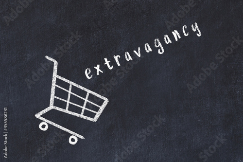Chalk drawing of shopping cart and word extravagancy on black chalboard. Concept of globalization and mass consuming photo