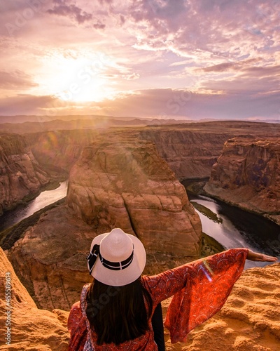 Woman sitting beside the horseshoe bend  in Glen Canyon National Recreation Area in Arizona,USA photo