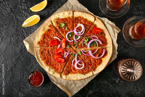 Delicious Turkish pizza on dark background