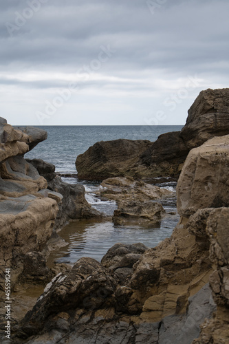 beach with rocks on the coast of the town of Morarira in the province of Alicante, Valencian community, Spain