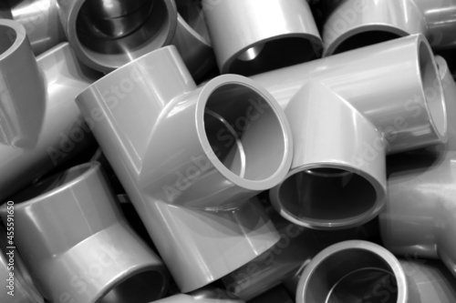 Фотография Grey pvc plumbing pipes corners background closeup