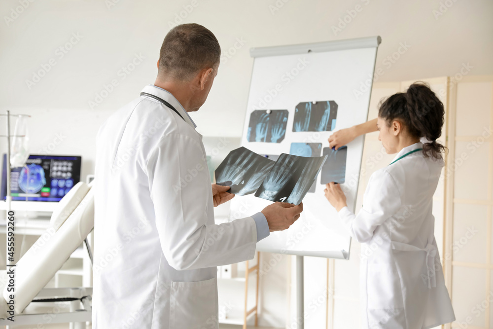 Doctors studying x-ray scans in clinic Doctors studying x-ray scans in clinic