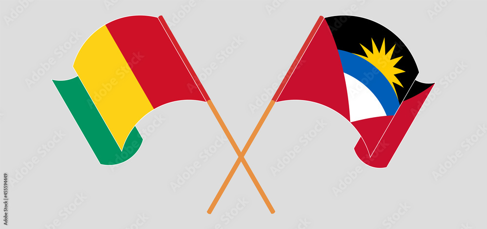 Crossed and waving flags of Guinea and Antigua and Barbuda Crossed and waving flags of Guinea and Antigua and Barbuda