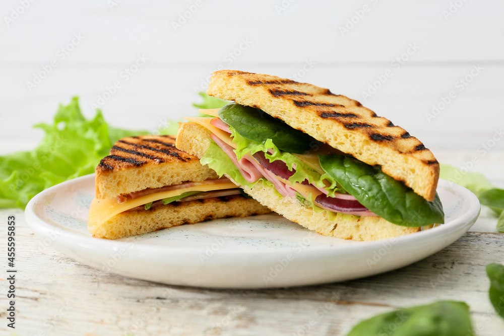 Plate with tasty sandwiches on light background, closeup Plate with tasty sandwiches on light background, closeup
