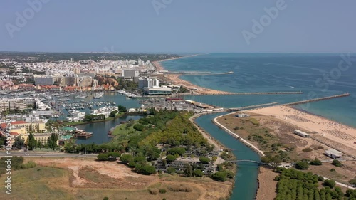 Aerial video of the tourist Portuguese town of Vilamoura, with views of the beaches and docks for luxury yachts, hotels and restaurants. Portugal, Algarve.