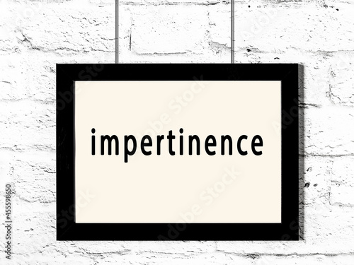 Принти на полотні Black frame hanging on white brick wall with inscription impertinence