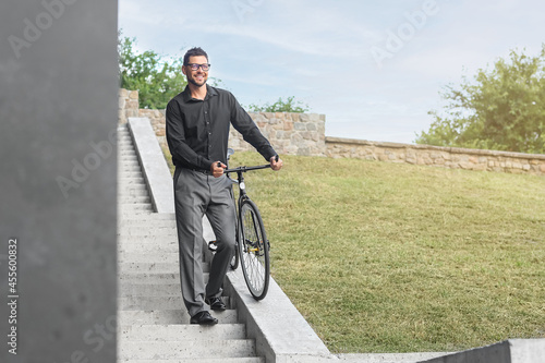 Businessman with bicycle going downstairs