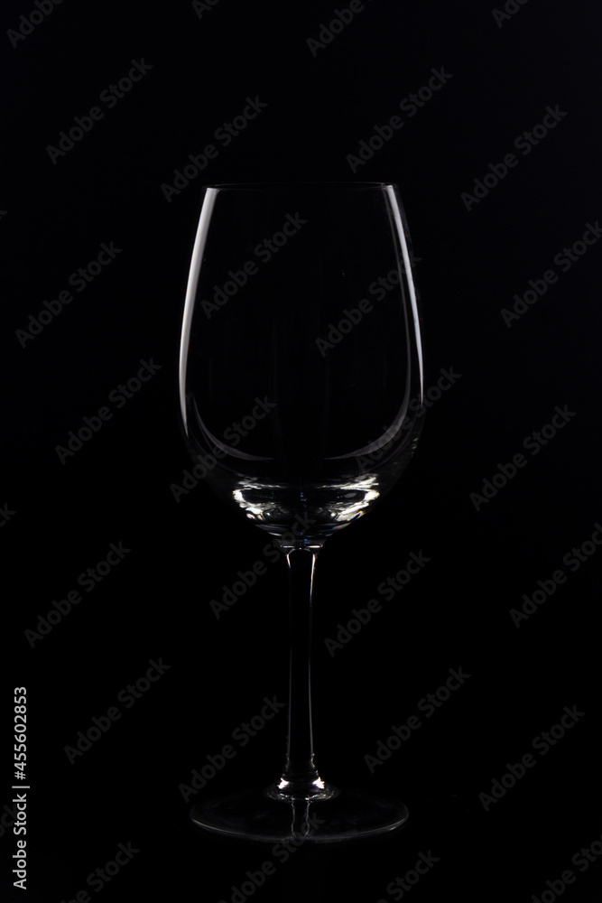 wine glasses and bottles with liquids marking their silhouette with light and black background wine glasses and bottles with liquids marking their silhouette with light and black background