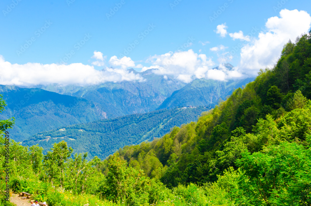 Fototapeta premium Mountain view in summer on a sunny day with clouds in the sky