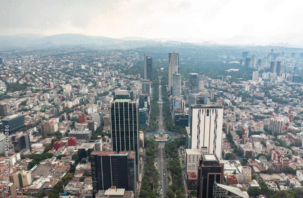 Aerial view of the Angel of Independence surrounded by greenery and commercial and financial building in Mexico City during day