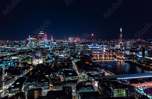 Beautiful night view of London city with illuminated lights from building and streets under black sky © 21AERIALS
