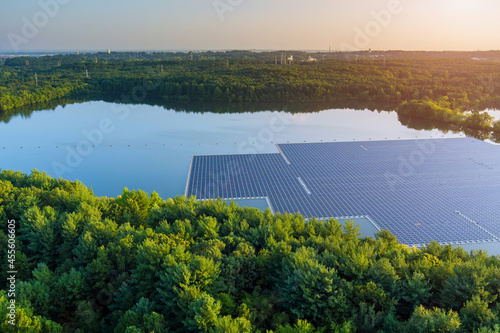 Aerial view of lake in renewable alternative electricity on floating solar panels platform photo