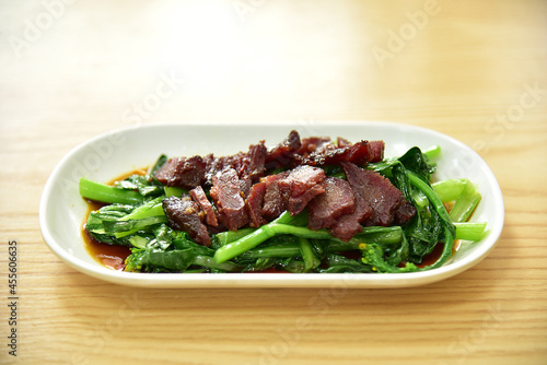 Honey char siu or honey-glazed barbecue pork and Choy Sum or Chinese flowering cabbage. Authentic Chinese Food, delicious cantonese gourmet.