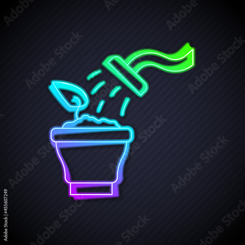 Glowing neon line Spraying a house plant with a spray gun icon isolated on black background. Moistening of foliage. Care for home flowers. Vector