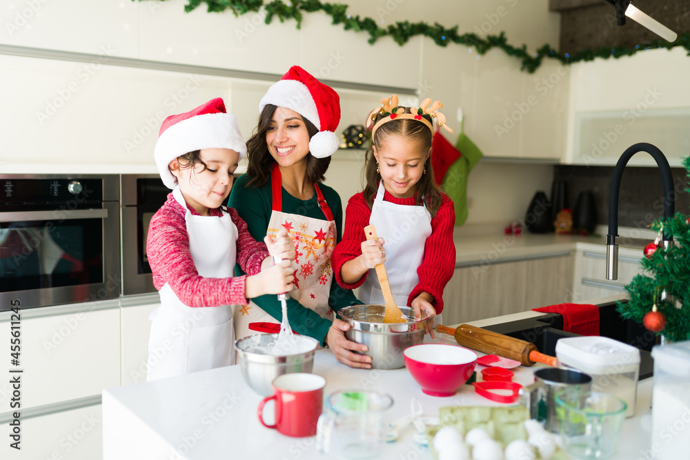 Caucasian family with santa hats in the kitchen