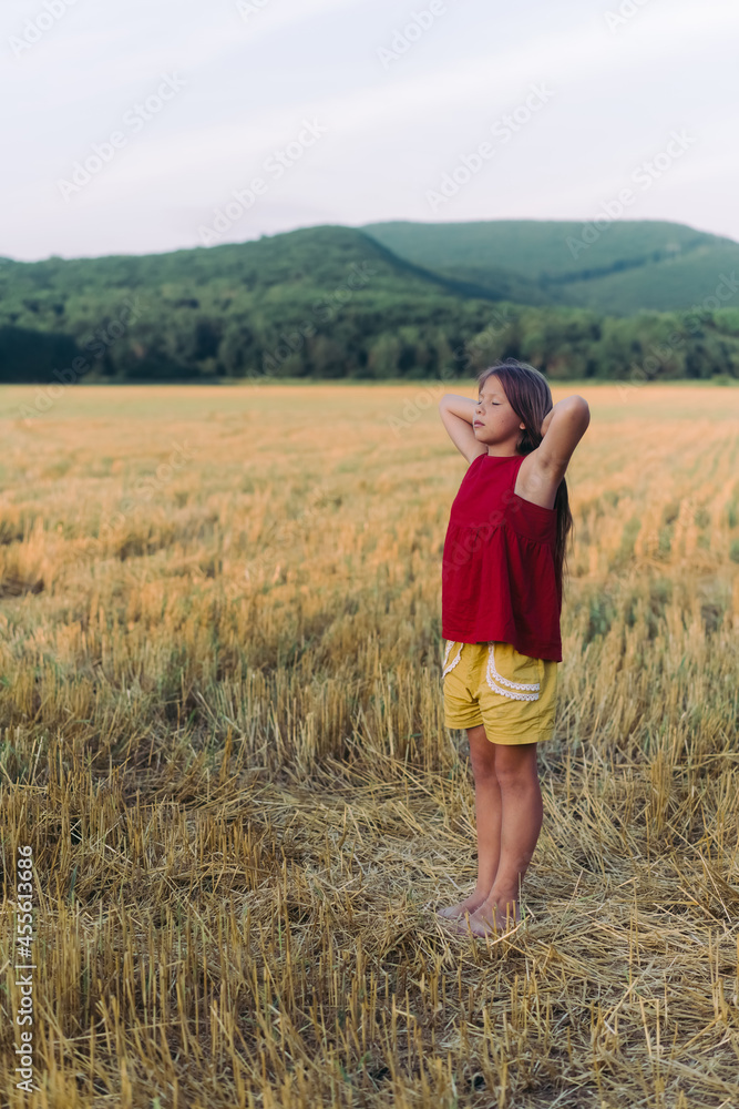 Side view portrait of happy beautiful girl breathing fresh air in field, outdoors. High quality photo