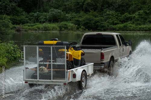 Pickup truck pulling trailer crossing a mighty river in Mexico, Sinaloa state.
