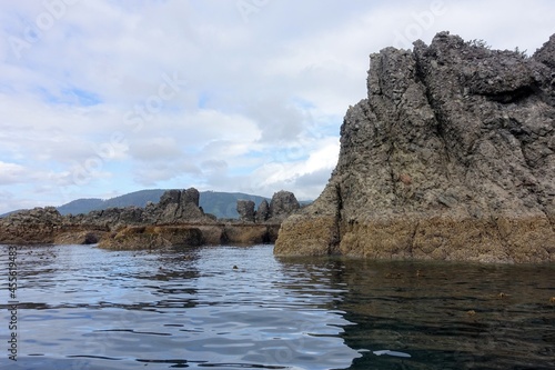 The high tide line in the rocks along a formation of small rocky islands in Gwaii Haanas, Haida Gwaii, British Columbia, Canada.