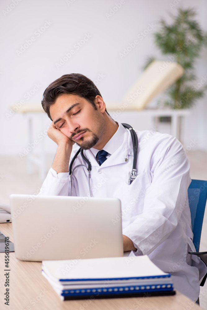 Young male doctor working in the clinic Young male doctor working in the clinic