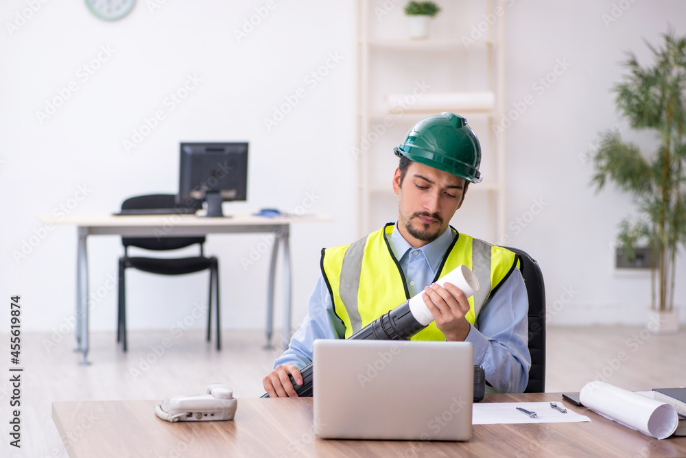 Young male architect working in the office Young male architect working in the office