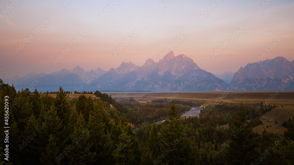 Teton Mountain Range at Sunrise with Forest Fire glow
