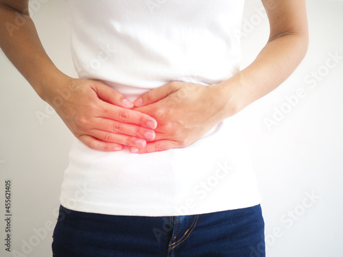Woman suffering abdominal pain on the side due to salpingitis. closeup photo, blurred. photo