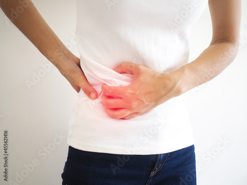 A woman suffers lateral abdominal pain due to salpingitis. health concept. closeup photo, blurred. photo