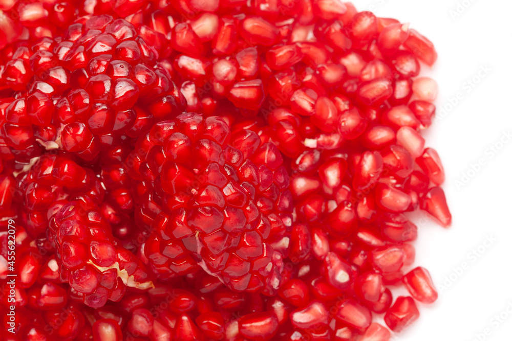 Micro Close-up of organic red pomegranate seed (Punica granatum) isolated over white background. Micro Close-up of organic red pomegranate seed (Punica granatum) isolated over white background.