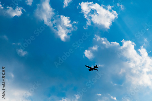 The plane was flying in the sky with white clouds. © Palakorn Jaiman