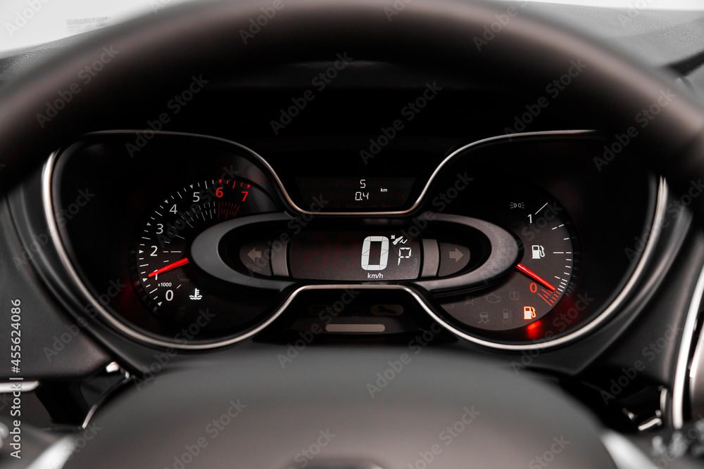 dashboard of the car is illuminated by bright illumination. Speedometer, circle tachometer, oil and fuel level