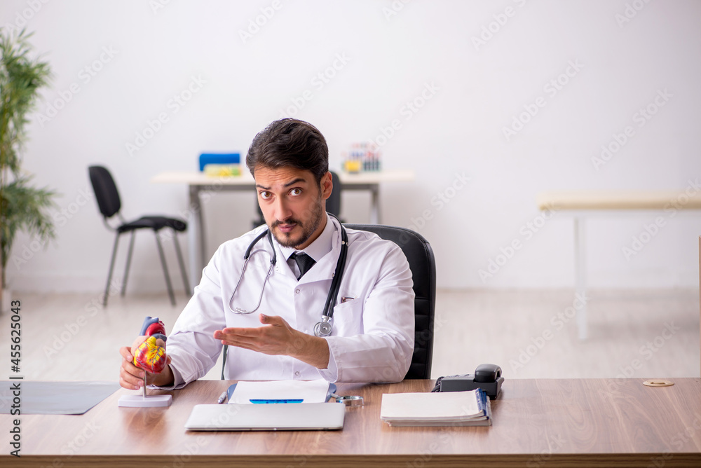 Young male doctor cardiologist working in the clinic Young male doctor cardiologist working in the clinic