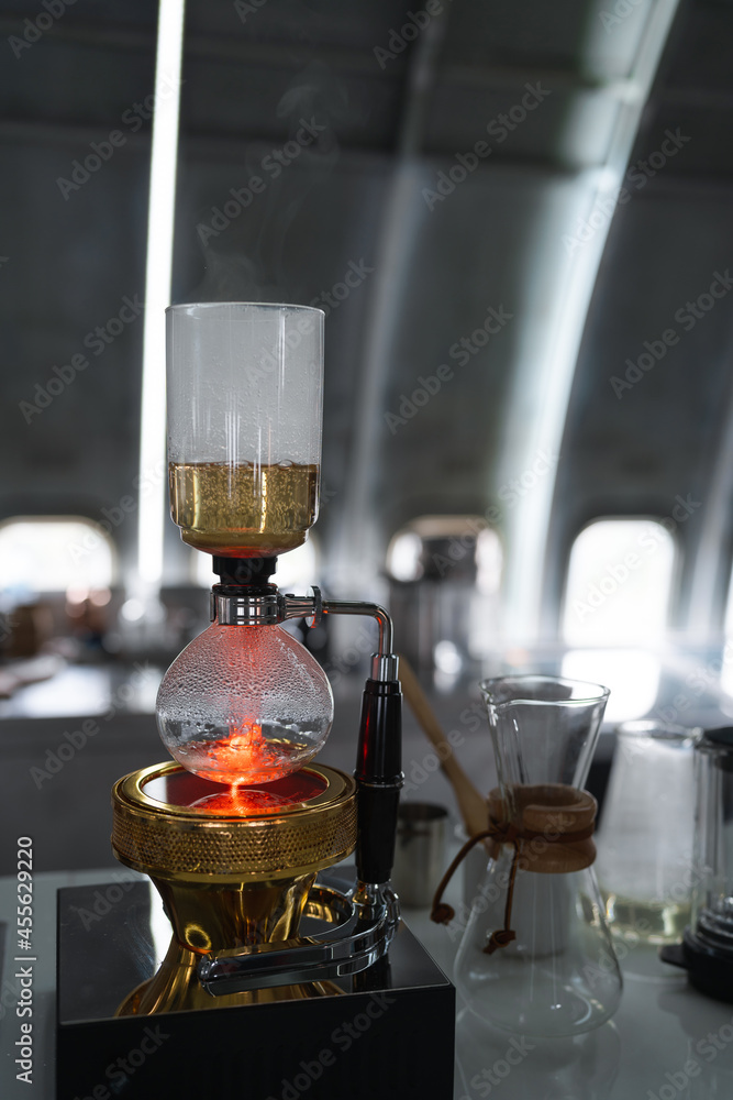 closeup Syphon Coffee Maker brewing hot espresso on table bar in coffee shop closeup Syphon Coffee Maker brewing hot espresso on table bar in coffee shop