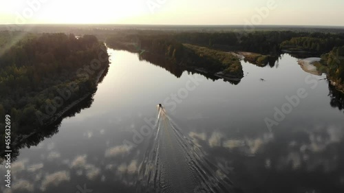 A white speedboat moving fast on water. Aerial view of fast boat movement. Lonely boat, movement on the water.