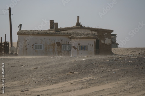 Aralsk, Kazakhstan - 10.05.2020 : Abandoned and dilapidated walls of houses on the territory of the village near the Aral Sea