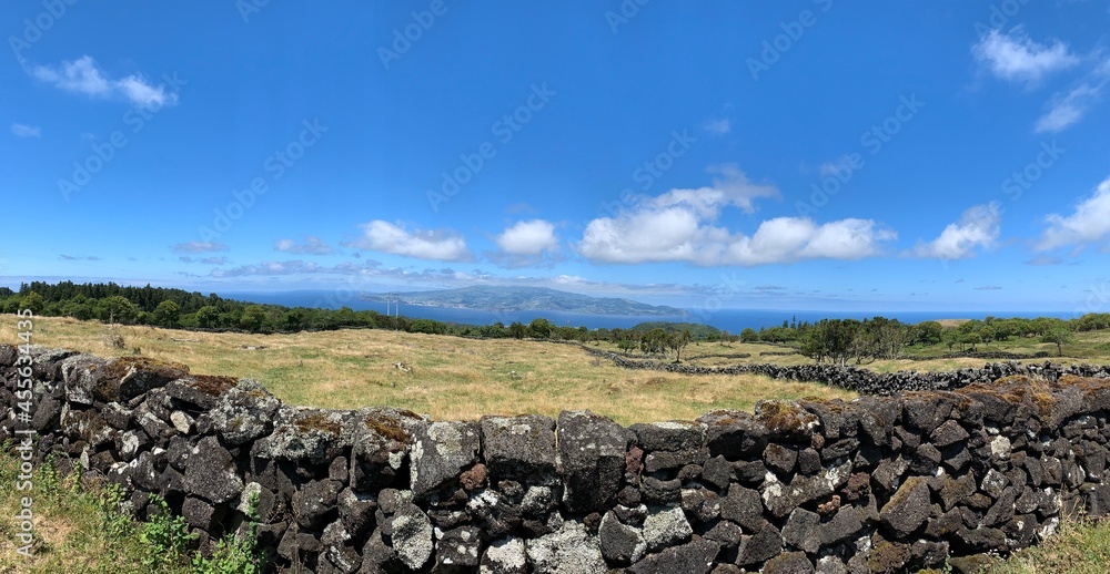 panorama landscape with sky and clouds at Pico Island, Azores, with Faial Island in Background