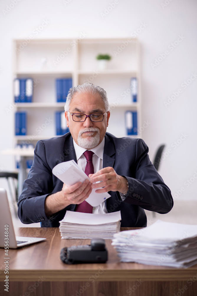 Old male employee and too much work in the office Old male employee and too much work in the office