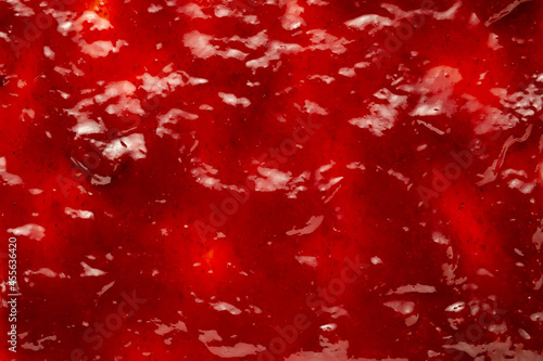 Background texture of delicious berry jam with fruit chunks