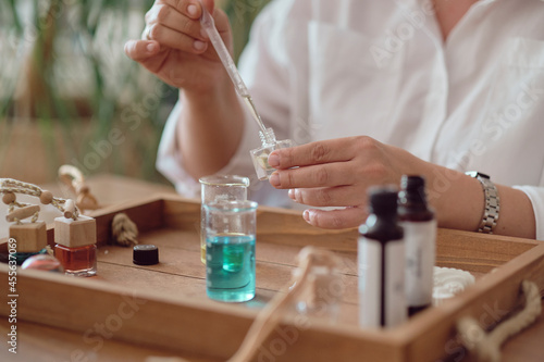 Tableau sur toile Close-up of a pipette with oil and a glass bottle
