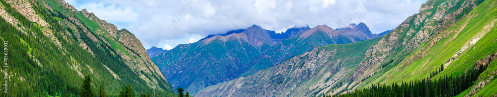 Majestic mountains and green grassland in Xiata Scenic Area,Xinjiang,China.