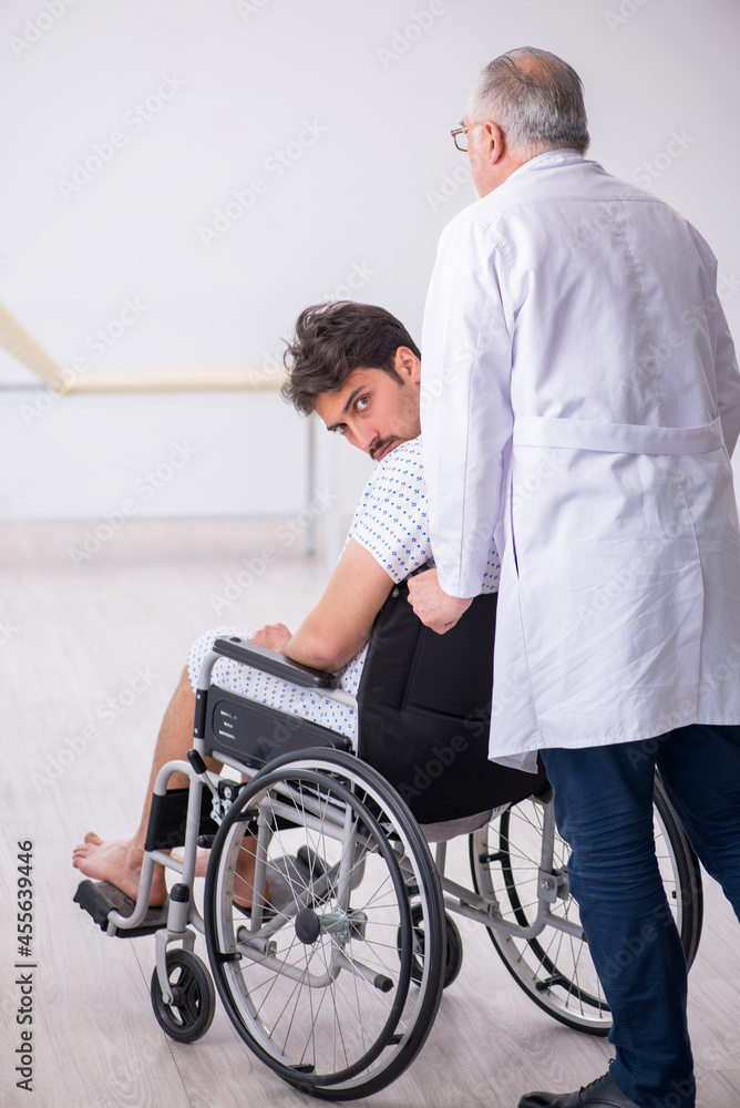 Old male doctor psychiatrist examining young disabled patient Old male doctor psychiatrist examining young disabled patient