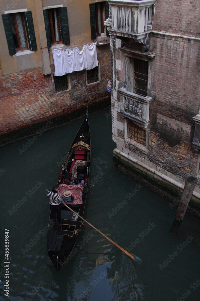 Venice, Italy People enjoying a ride in a gondola in Venice.