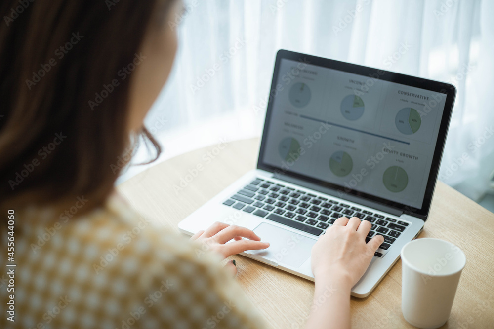 A young female officer summarizing data to create into an infographic for presentation A young female officer summarizing data to create into an infographic for presentation