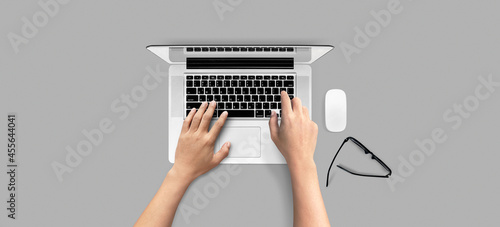 Top view of open laptop with hands typing on keyboard isolated on white background. of free space for your copy, view from top. Clipping path.