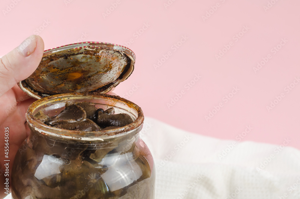 Botulism, food poisoning from canned foods concept. Handholds Rusty tin