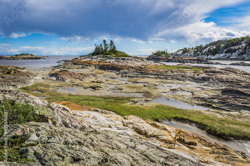 Rocky shoreline on the St Lawrence river near Raguneau in Cote Nord of Quebec, Canada photo