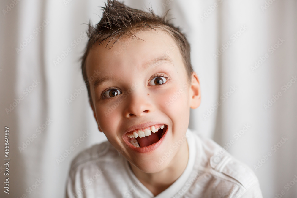 Home portrait of a little boy looking at the camera. Interesting look. Surprise on the face. To be surprised Home portrait of a little boy looking at the camera. Interesting look. Surprise on the face. To be surprised
