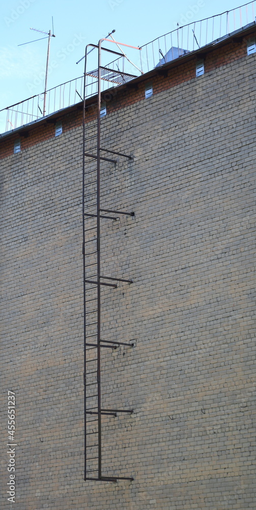 Fototapeta premium Metal fire escape on a brick wall