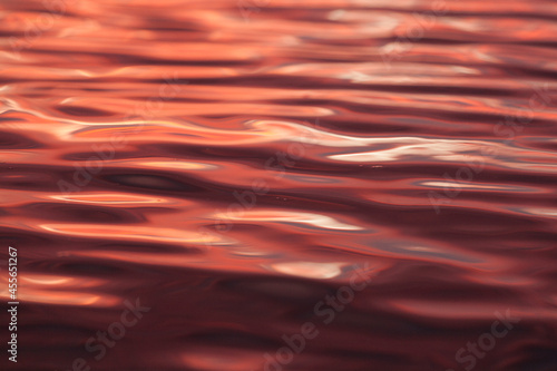 red reflection in water, metallic red water, abstract background