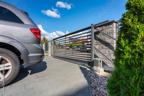 Canvas-taulu Driveway of a modern single-family house with an automatic gate