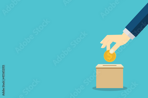 Donate, donation concept. Human hand with gold coin and donation box.